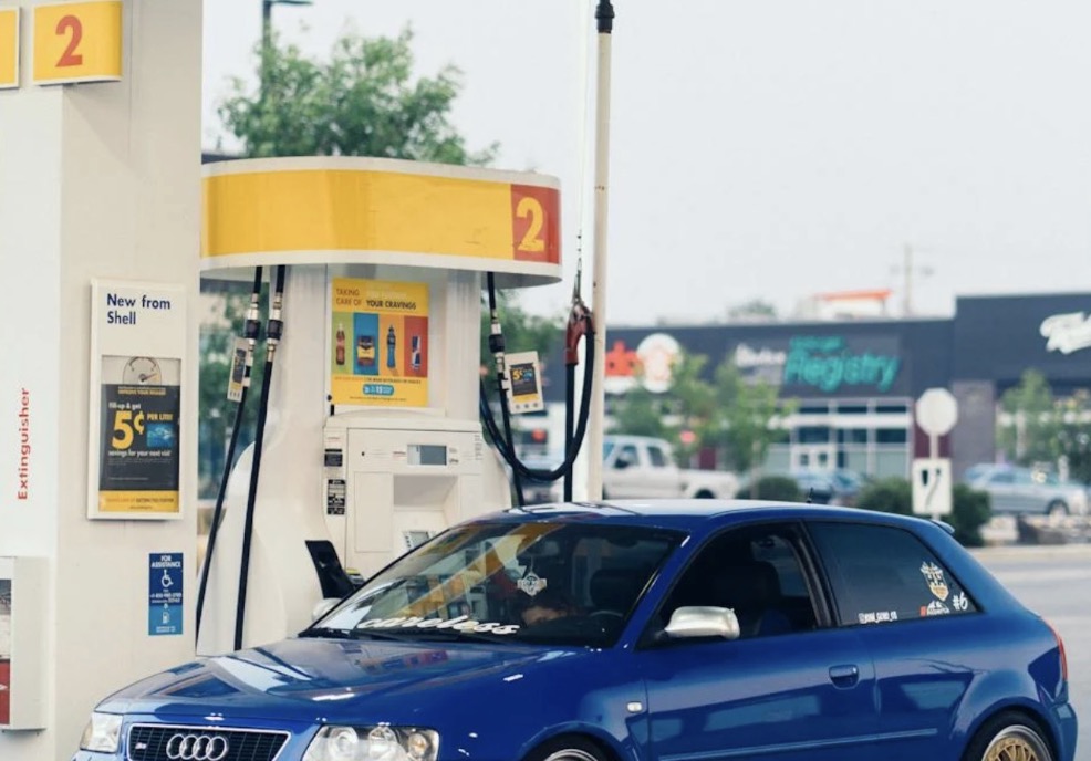 Blue car parked at a gas station